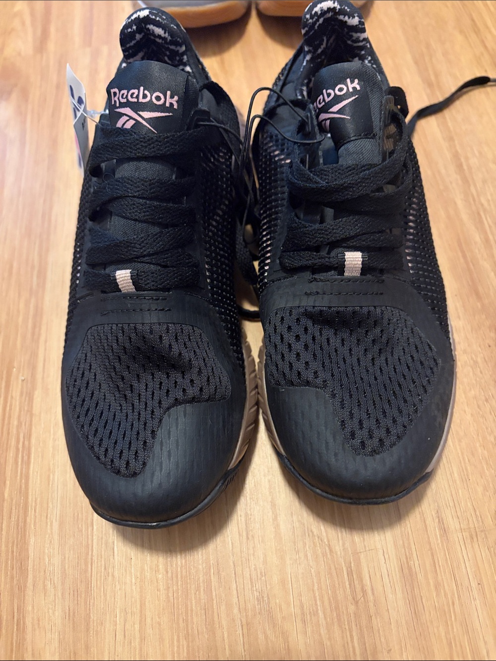 Reebok women’s Black Sneakers with Pink Logo Accents